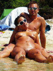 Nudist couples sunbathing nude on the..
